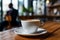 Aromatic coffee in a white cup on a wooden table, businessman