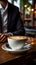 Aromatic coffee in a white cup on a wooden table, businessman