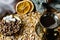 Aromatic dark coffee with bubbles on the surface in a dark gold Cup on a saucer, next to whole grains, peeled and dried oranges