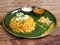 Aromatic delicious Egg Biryani - Basmati rice cooked with masala spices and served with along with sliced boiled egg, gravy, onion