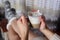 Aromatic Delight: Woman\\\'s Hands Cradling a Steamy Cup of Coffee with Milk Foam