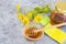 Aromatic flower honey, wild flowers on gray background.