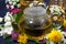 Aromatic flower tea and honey in a teapot, closeup