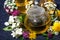 Aromatic flower tea and honey in a teapot, top view