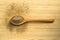 Aromatic fresh powdered black pepper ground, in spoon on wooden bamboo cutting board