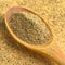 Aromatic fresh powdered black pepper ground, in spoon on wooden bamboo cutting board