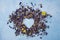 Aromatic herbal dry tea lavender and chamomile loose heart  on blue wood table copy space