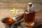 Aromatic homemade vanilla extract on wooden table, closeup. Space for text