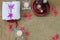 Aromatic oil in grunge wooden bowl, burned candle, pink flowers, white towel on vintage grunge stone background