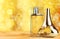 Aromatic perfume bottles on golden background