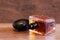 Aromatic perfume bottles on wooden desk at wooden background