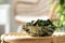 Aromatic potpourri of dried flowers in bowl on wicker table indoors