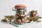 Aromatic potpourri in glass jar on white table