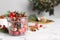 Aromatic potpourri in glass jar on white table. Space for text