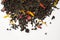 Aromatic, pungent, black tea with dry berries and flowers on white background.