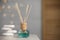 Aromatic reed air freshener and pebbles on wooden table. Space for text