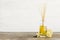 Aromatic reed freshener, lemon and vanilla on wooden table against light background.