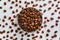 Aromatic roasted coffee beans scattered on a white background