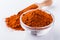 Aromatic spicy chili powder on a white background