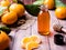 Aromatic tangerine oil, with tangerines on a wooden background, selective focus