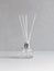Aromatizer. Aromatic air freshener in a transparent glass bottle with white reeds on a gray background