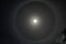 Around the moon in the night sky has formed the huge halo circle