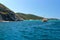 ARRAIAL DO CABO, RIO DE JANEIRO, BRAZIL- MARCH 21, 2016: Sailboat and a boat over a green and clear waters near a coast.