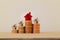 Arrange red outstanding small house or home on stacks of coins