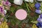arranged leaves and flowers and pink circle as copy space, natural meadow background craetive design