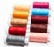 Arranged in lines multicolor sewing threads on white background