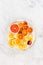 Arrangement of Cut Grapefruit, Oranges, Blush Oranges and Lemon on White Plate
