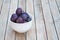 Arrangement of damson plums on wooden boards