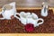 An arrangement of heart cups on a tray with coffee beans