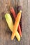 Arrangement of heritage carrot varieties against a rustic wooden background