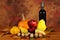 Arrangement of pumpkins, autumn fruits and wine