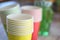 Arrangement of recycling disposable colorful paper cups, glass of red, yellow color