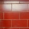 The arrangement of red ceramics that resembles a brick wall that shines in the sun