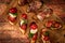 Arrangement of a selection of different tapas or bruschettas on a wooden board. Mediterranean food concept