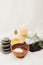 arrangement of spa treatment accessories and chrysanthemum flower in wooden bowl