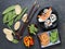 Arrangement of sushi with chopsticks, pickled vegetables and peppers