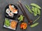Arrangement of sushi with chopsticks, pickled vegetables and peppers