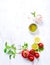 An arrangement of tomatoes, basil, olive oil and himalayan salt