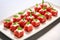 arrangement of watermelon chunks and feta cheese on a rectangle platter