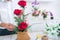 Arranging artificial flowers decoration at home, Young woman florist work making organizing diy artificial flower, craft and hand