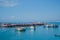 Array of boats docked near each other in the sea with the smaller boats situated on the shore