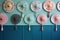 array of decorative hand fans hanging on a pastel blue wall