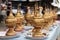 Array of elegant golden Burmese Lacquer  and bowls are artfully arranged on a table