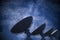 Array of satellite dishes or radio antennas against night sky. Space observatory. 3D rendered illustration