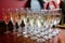 Array of sparkling crystal glasses filled with champagne atop a rustic wooden table