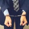 arrested businessman in handcuffs. Businessman bribetaker or bri